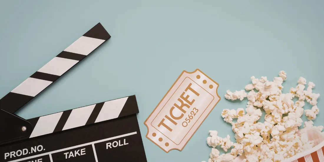 Clapper board, movie ticket, and popcorn