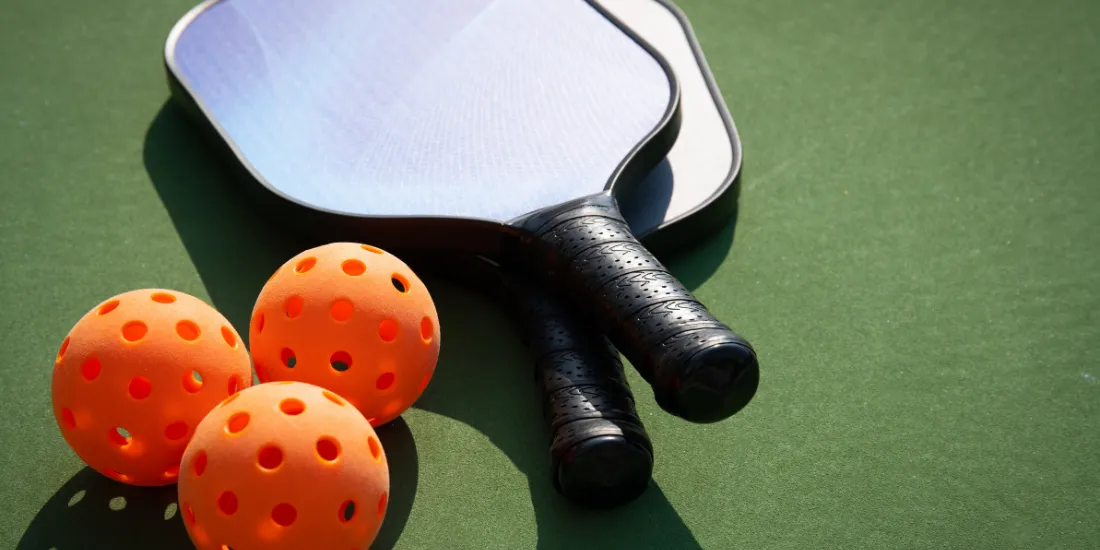 Pickleballs and paddles