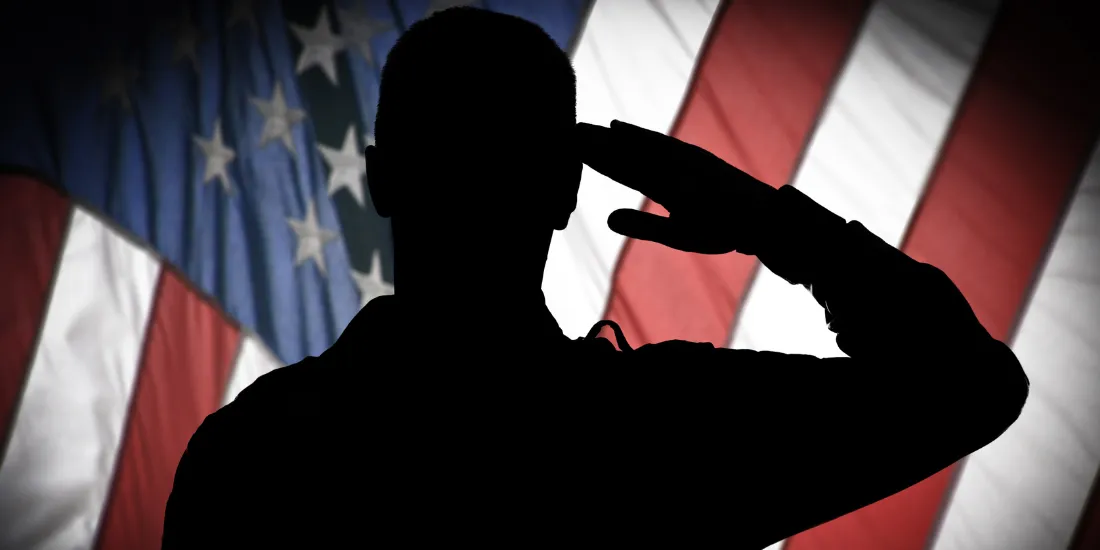 silhouette of solider saluting American flag