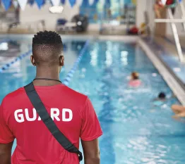 Lifeguard monitors children in pool