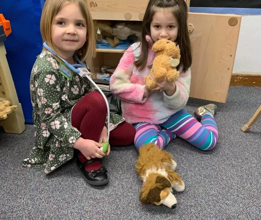 girls playing with stuffed animals